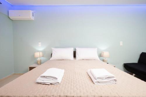 a bedroom with a bed with towels on it at Corfu Blue Memories Apartment 2 in Corfu Town