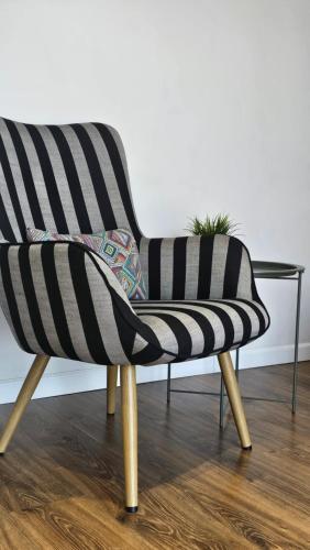 a black and white chair with a glass table at Black Room Apartment in Mukacheve
