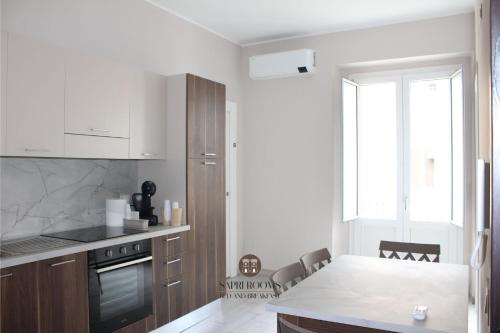a kitchen with a table and a counter top at Sapri Rooms in Lamezia Terme