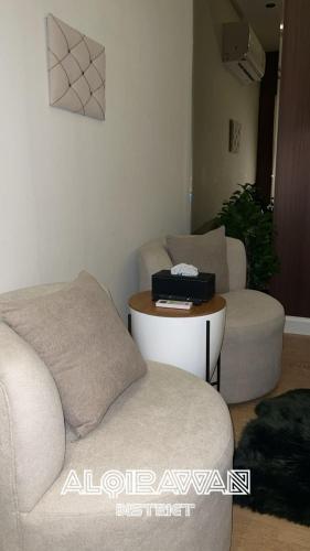 a living room with a couch and a table at Quiet studio with comfortable hotel bed in Riyadh