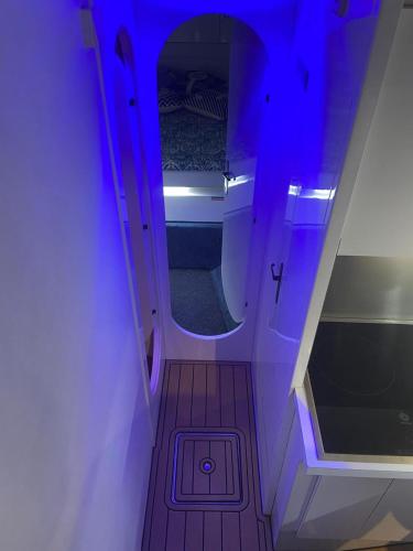 a small room with a purple light on a boat at The Sailor Charter in Portimão