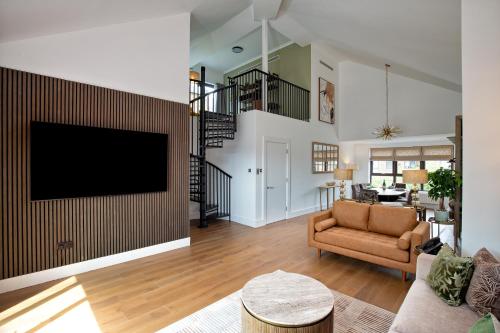 a living room with a tv on a wall at Monarch House - Serviced Apartments - Kensington in London
