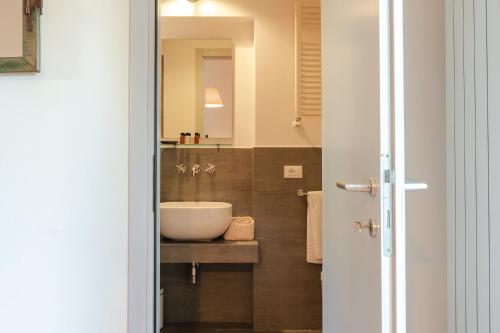 a bathroom with a sink and a mirror at Borgo Syrah in Cortona