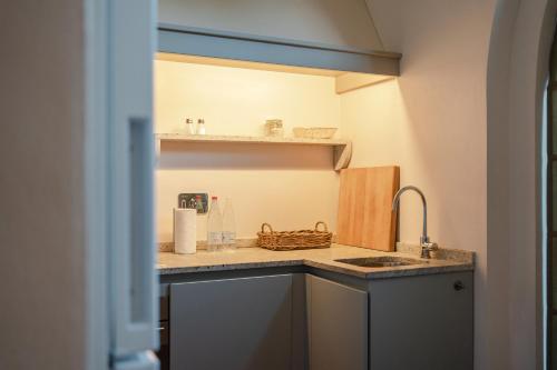 a kitchen with a sink and a counter top at Borgo Syrah in Cortona