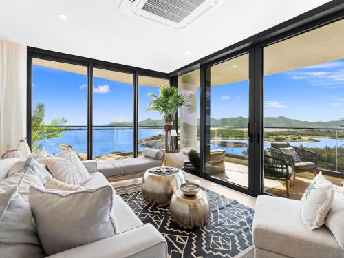 a living room with large windows and a view of the water at Fourteen at Mullet Bay in Cupecoy