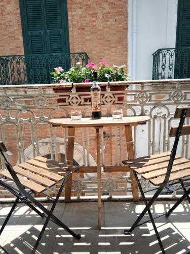 a bottle of alcohol sitting on a table on a patio at Il Vicoletto in Pisticci