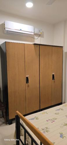 a room with two lockers with a heater on the ceiling at Soni & Avi Home in Igatpuri