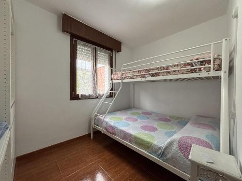 a bedroom with two bunk beds and a window at Ortuella Apartment in Ortuella