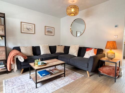 a living room with a couch and a table at Kerensa 3 bed townhouse located close to the beach with Parking in Penzance
