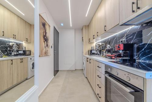 a large kitchen with wooden cabinets and appliances at NS Elvagia in Amoudara Herakliou