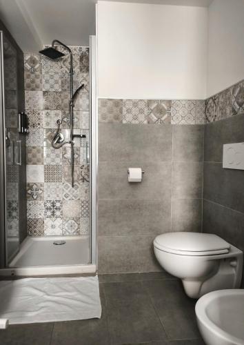 a bathroom with a shower and a toilet and a sink at Il Vicoletto in Pisticci