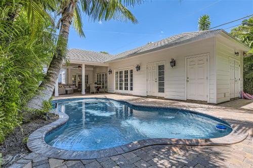 a swimming pool in front of a house at Palm Beach Oasis - Indulge in Garden Tranquility with Alfresco Dining in West Palm Beach