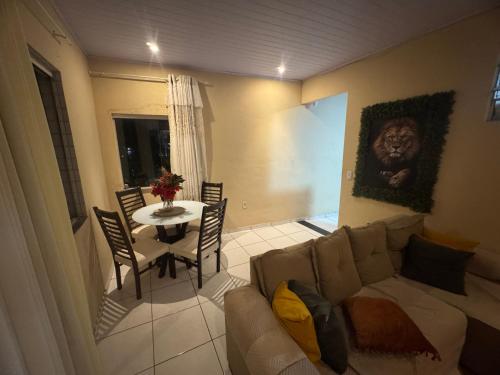 a living room with a couch and a table at Suite climatizada em Ap compartilhado na ponta da areia in Vinhais