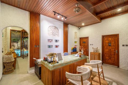 a kitchen with a counter and chairs in a room at Casa Maddu in Tegalalang
