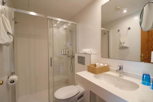 a bathroom with a toilet and a sink and a shower at Bonavida Apartments in Port d'Alcudia