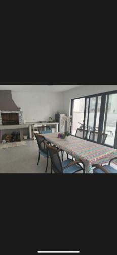 a table and chairs in a room with a window at Villa Vida, Medulin - Bazen i jacuzzi in Medulin