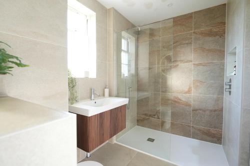 a bathroom with a sink and a shower at Four bedroom detached family home near Elie in Kilconquhar