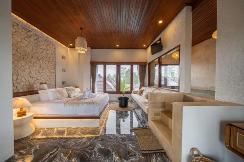 a bedroom with a large bed in a room at Casa Maddu in Tegalalang