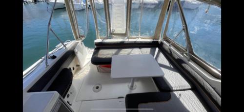 a boat with a table in the middle of the water at Logement insolite French Riviera avec parking in Antibes
