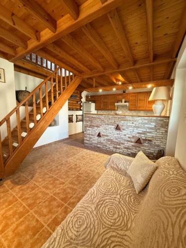 a bedroom with a large bed and a staircase at Traditional House in Pámfylla
