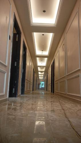 an empty hallway in a building with a ceiling at Hotel Presidency - Best Hotel in Surat in Surat