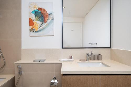 a bathroom with a sink and a mirror at Stylish 2BR with Boulevard View & 5 min from Dubai Mall in Dubai