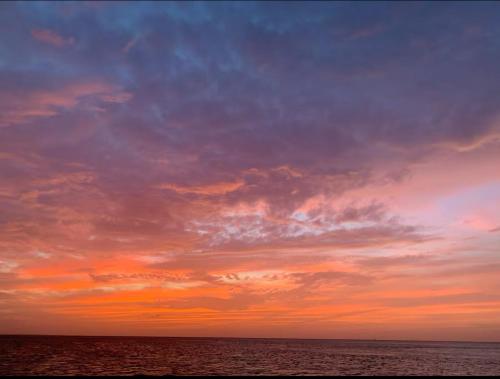 a cloudy sky over the ocean at sunset at Luxury Grace Escape in Long Bay Hills