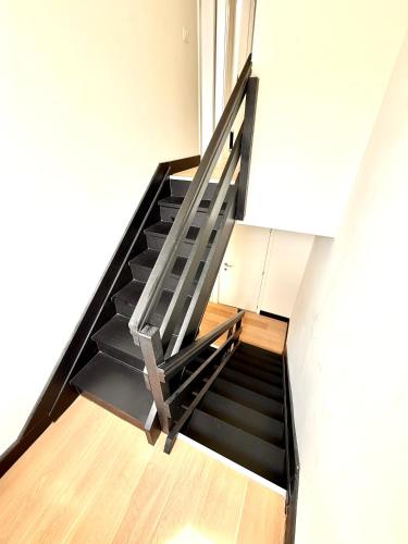 a staircase in a room with a stair case at ULB & Cambre Cosy Duplex in Brussels
