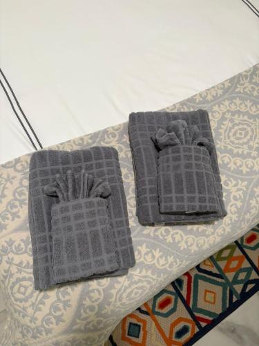 two towels sitting on top of a table at Spacious Modern 5-Bedroom House, Close to Downtown Tampa in Tampa