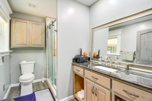 a bathroom with a toilet and a sink and a shower at 13 Mi to Guntersville Lake Henagar Gem with Hot Tub in Pisgah
