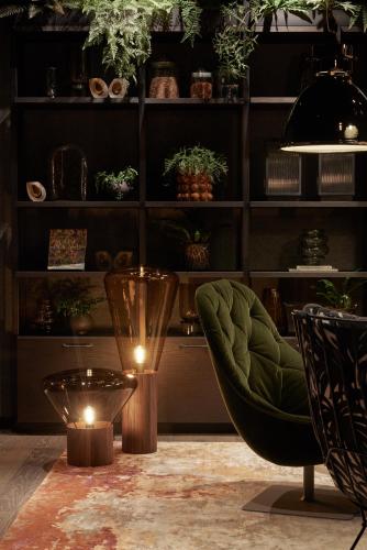 a room with a chair and a table with lights at The Cloud One Gdansk in Gdańsk