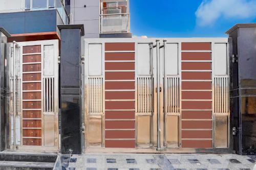 a building with red and white doors on it at Collection O Sector 93 Noida Expressway in Noida