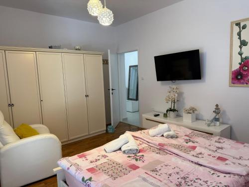 a bedroom with a bed and a tv on a wall at Villa Vida, Medulin - Bazen i jacuzzi in Medulin
