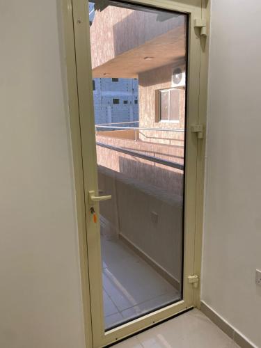 a glass door with a window in a room at سيتي قولد للشقق الفندقيه in Taif