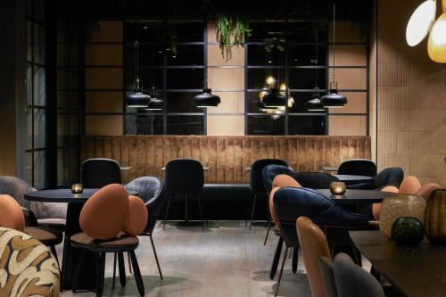 a restaurant with chairs and tables and a bar at The Cloud One Gdansk in Gdańsk