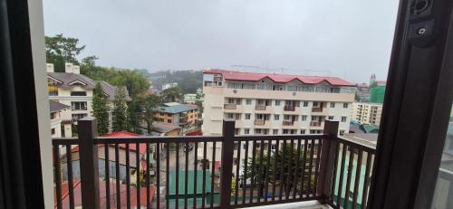 a view of a city from a balcony at CozyNest Rentals at Brenthill Condominium in Baguio