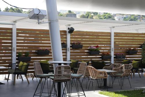 a group of chairs and tables on a patio at BluePoint Hotel in Tepelenë