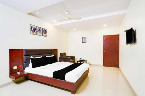 a bedroom with a bed and a television in it at Collection O Gudivada in Gudivāda