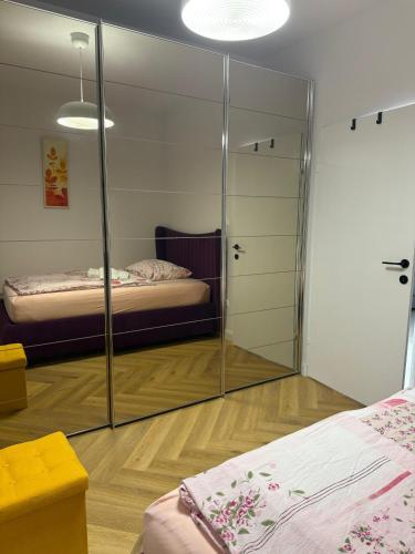 a room with two beds and a mirror at Villa Vida, Medulin - Bazen i jacuzzi in Medulin