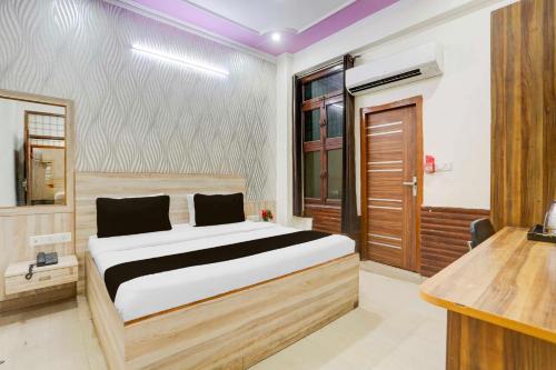 a bedroom with a bed and a wooden door at Collection O Sector 4 Gurgaon in Gurgaon