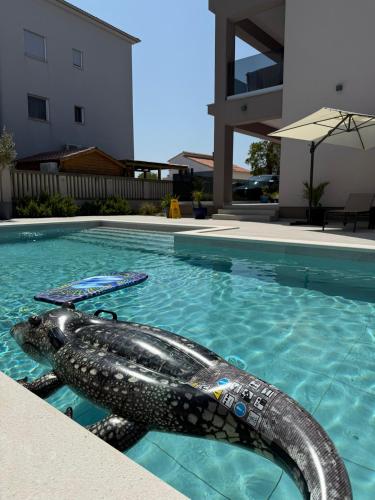 a mermaid swimming in a swimming pool at Villa Vida, Medulin - Bazen i jacuzzi in Medulin