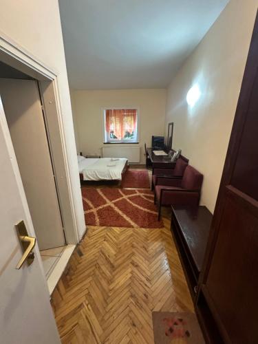 a living room with a bed and a couch at Prenociste PALIC in Palić