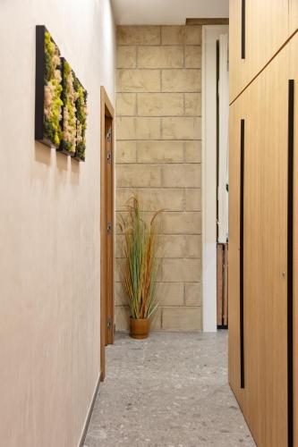 a hallway of a house with a plant on the wall at Fortunella Suites Luxury in Portici