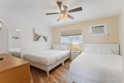 a bedroom with two beds and a ceiling fan at 6201 Ocean Ave, Unit 505 - The Nassau Inn in Wildwood