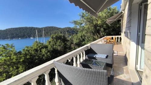 a balcony with chairs and a view of the water at Stella Maris - Family Apartment in Polače
