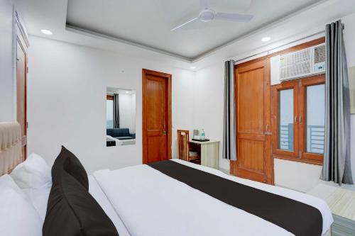 a bedroom with a white bed and a window at Collection O Sector 135 Noida in Noida