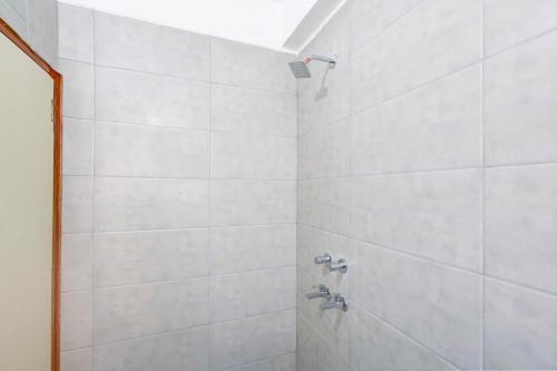 a bathroom with a shower with silver faucets at Collection O Sector 1 Manesar in Gurgaon