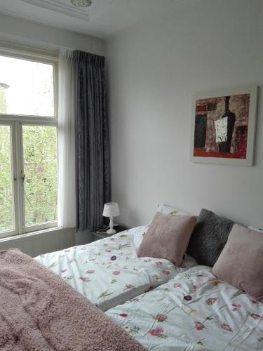 a bedroom with a bed and a window at City Lodge Stay A while in Zwolle