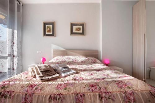 a bedroom with a bed with a phone on it at Grazioso Bilocale vicino Bergamo in Seriate