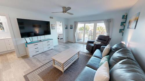a living room with a couch and a tv at SeaCrest 306 in Fort Walton Beach